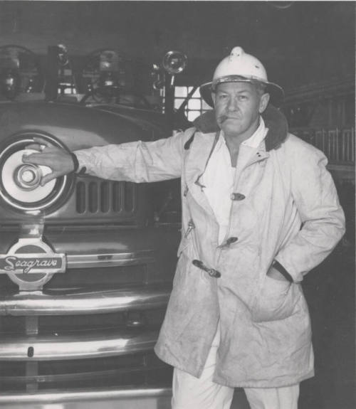 F. Reeves, Tempe Firechief Standing by Fire Engine