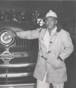 F. Reeves, Tempe Firechief Standing by Fire Engine