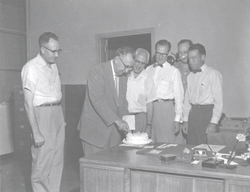 Administrators Sharing Cake with President Gammage