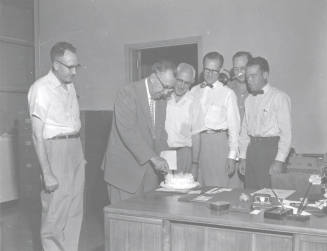 Administrators Sharing Cake with President Gammage
