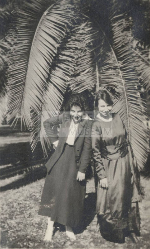 2 Coeds Standing by a Date Tree