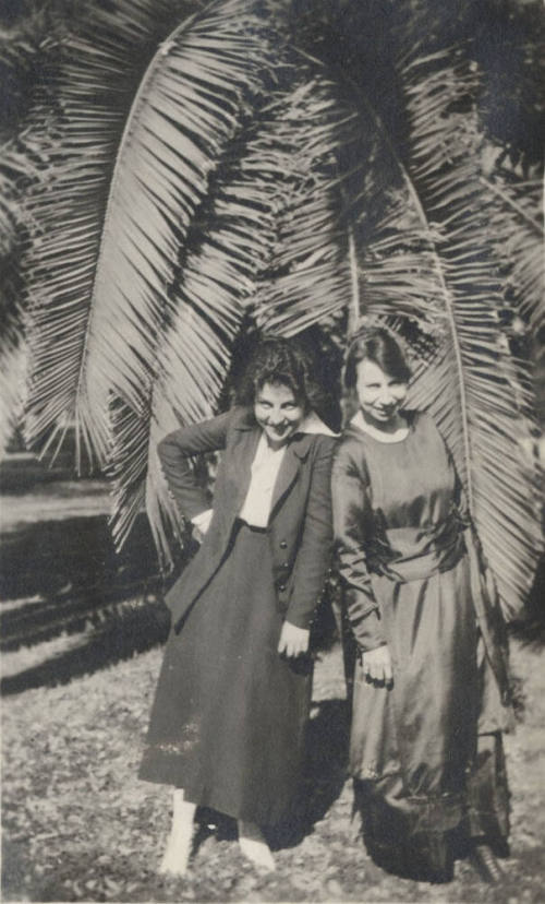 2 Coeds Standing by a Date Tree