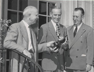 Ira D. Payne Showing Replica of Sun Devil to a Member of 1914 Class