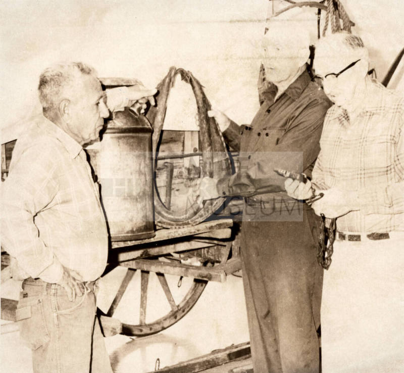Joaquin Bustoz, Milton Aepli and Gene Bishop Look at Museum Horse Collar