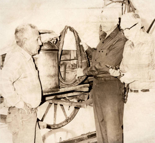 Joaquin Bustoz, Milton Aepli and Gene Bishop Look at Museum Horse Collar
