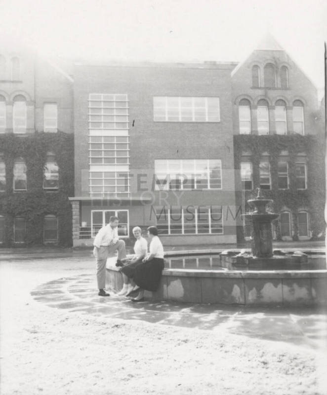 Students Sitting in Front of Old Main
