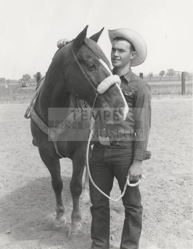 Cowboy Standing by Horse Holding Lead