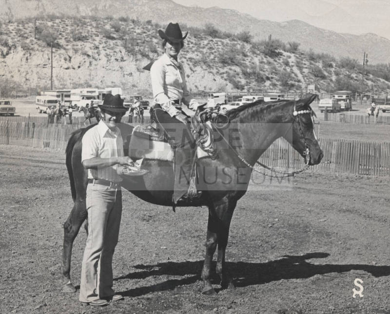Mitzi Thude in the Saddle on Winning Horse with Trainer Along Side