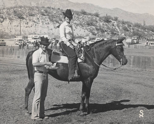 Mitzi Thude in the Saddle on Winning Horse with Trainer Along Side